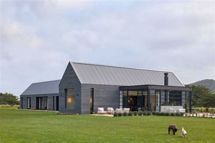 Who developed farmhouse architecture